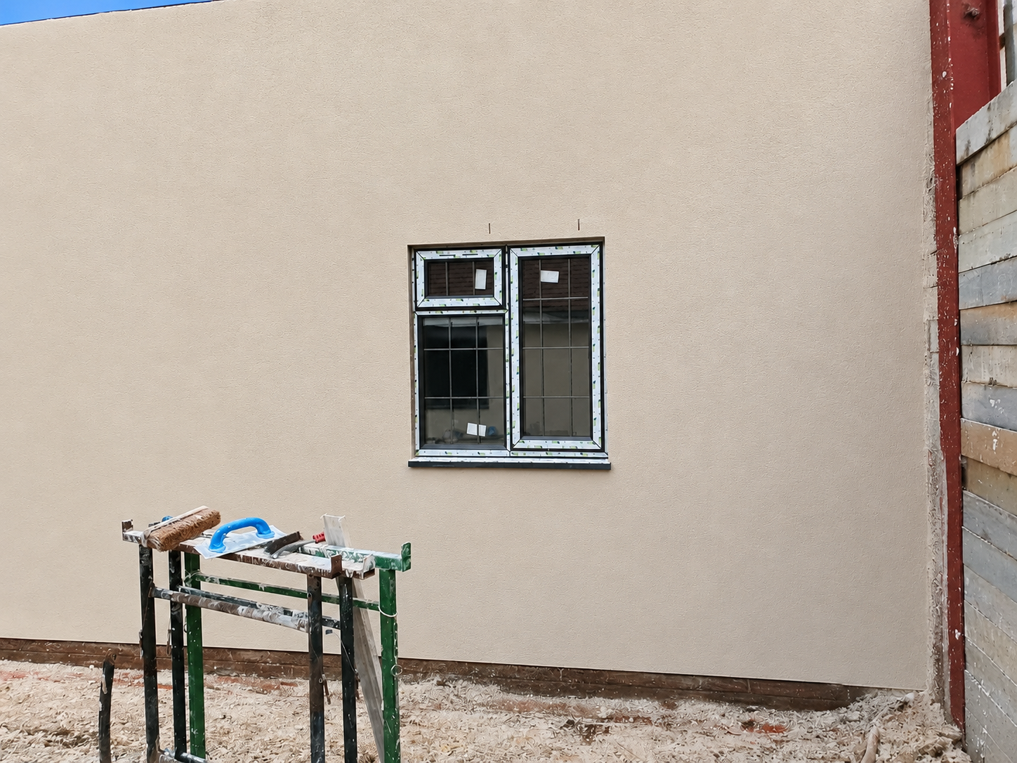 Same house facade after external wall insulation and render finish